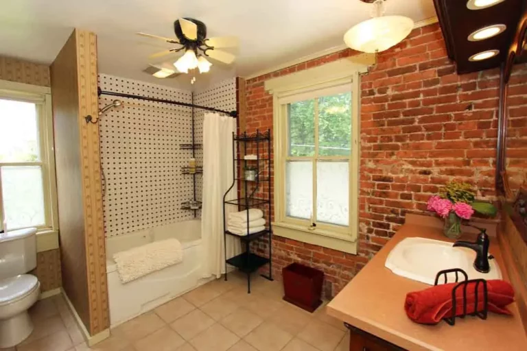 Bathroom with exposed brick wall.