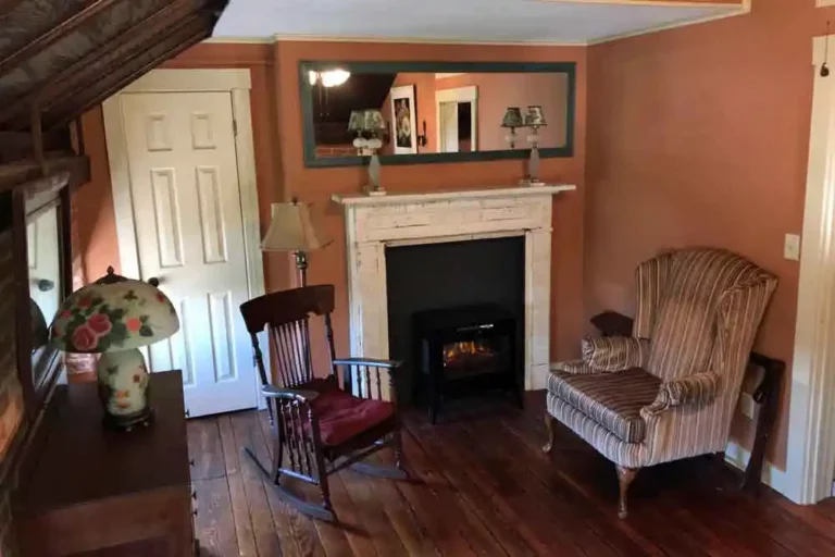 Sitting area with fireplace and rocking chairs.