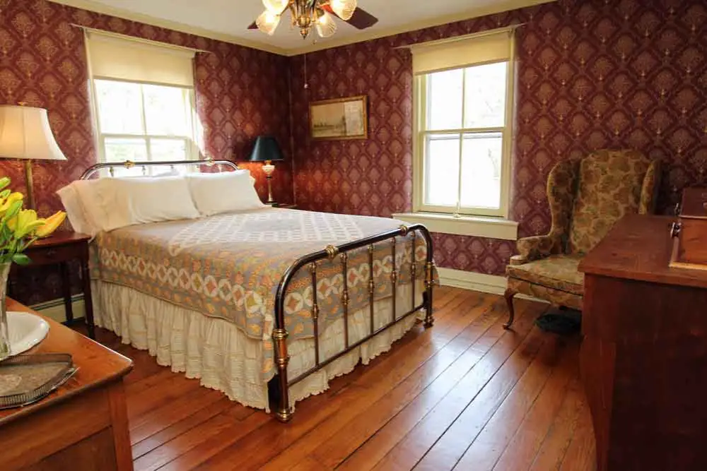 Vintage bedroom with iron bedstead.